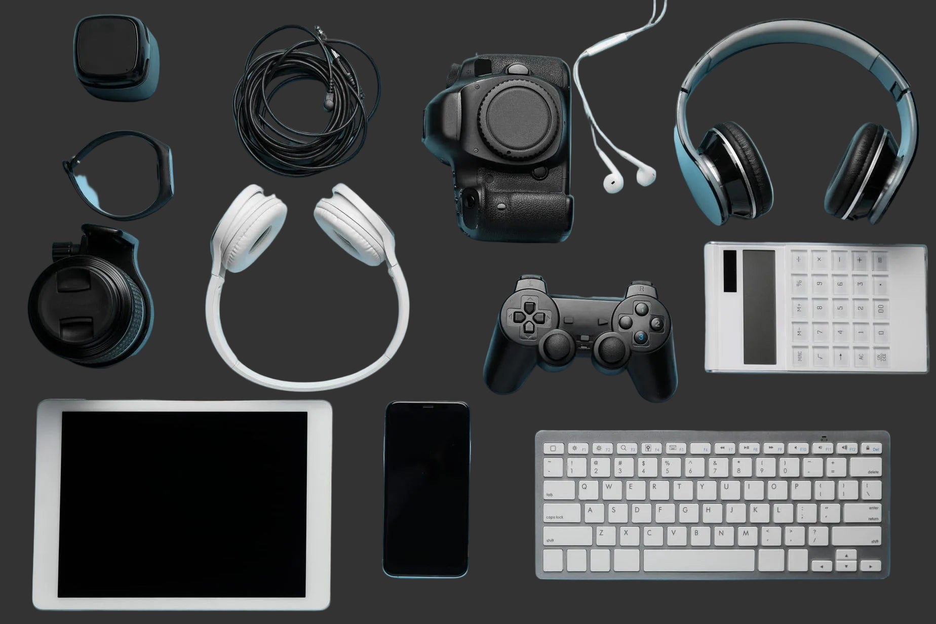Collection of electronic devices including a tablet, phone, keyboard, camera, and gaming controller on a blue background.